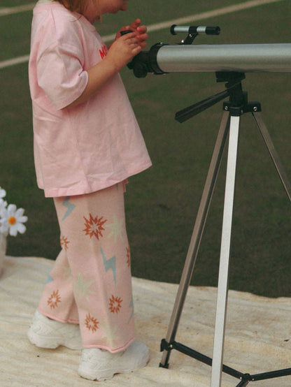 Child with a telescope on a tennis court