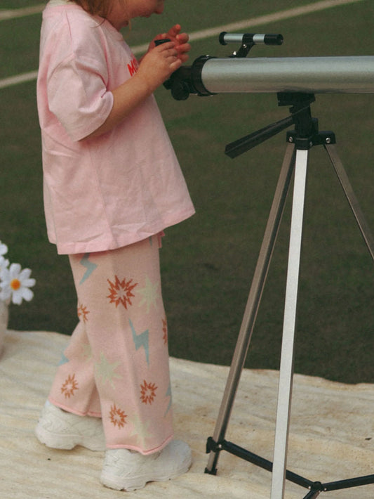 Child with a telescope on a tennis court